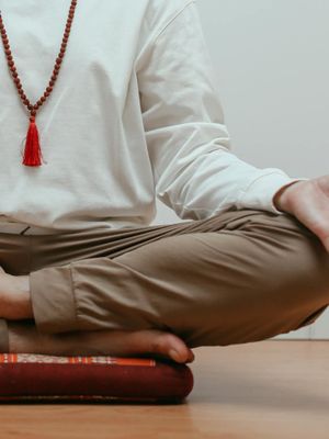 Close-up of a person's hands in a meditative mudra position.